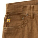 Close-up of Duck Head Field Canvas Five-Pocket pants, highlighting the stretch canvas waistband, belt loop, front pocket, and a yellow tag with black and white logo by the coin pocket.