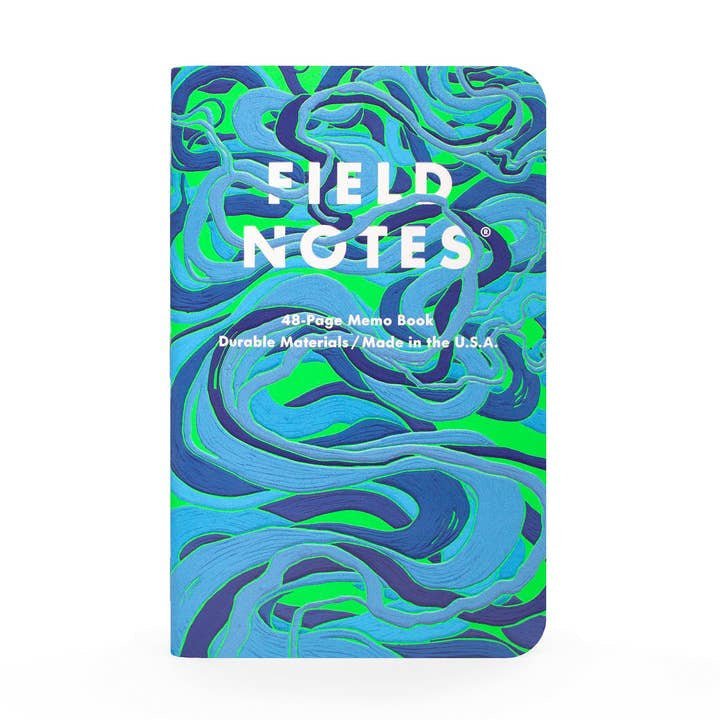 The "Is a River Alive? | Field Notes" 3-Pack features blue and green marbled, textured embossed covers with white "Field Notes" branding—an ideal companion for readers of Robert Macfarlane.