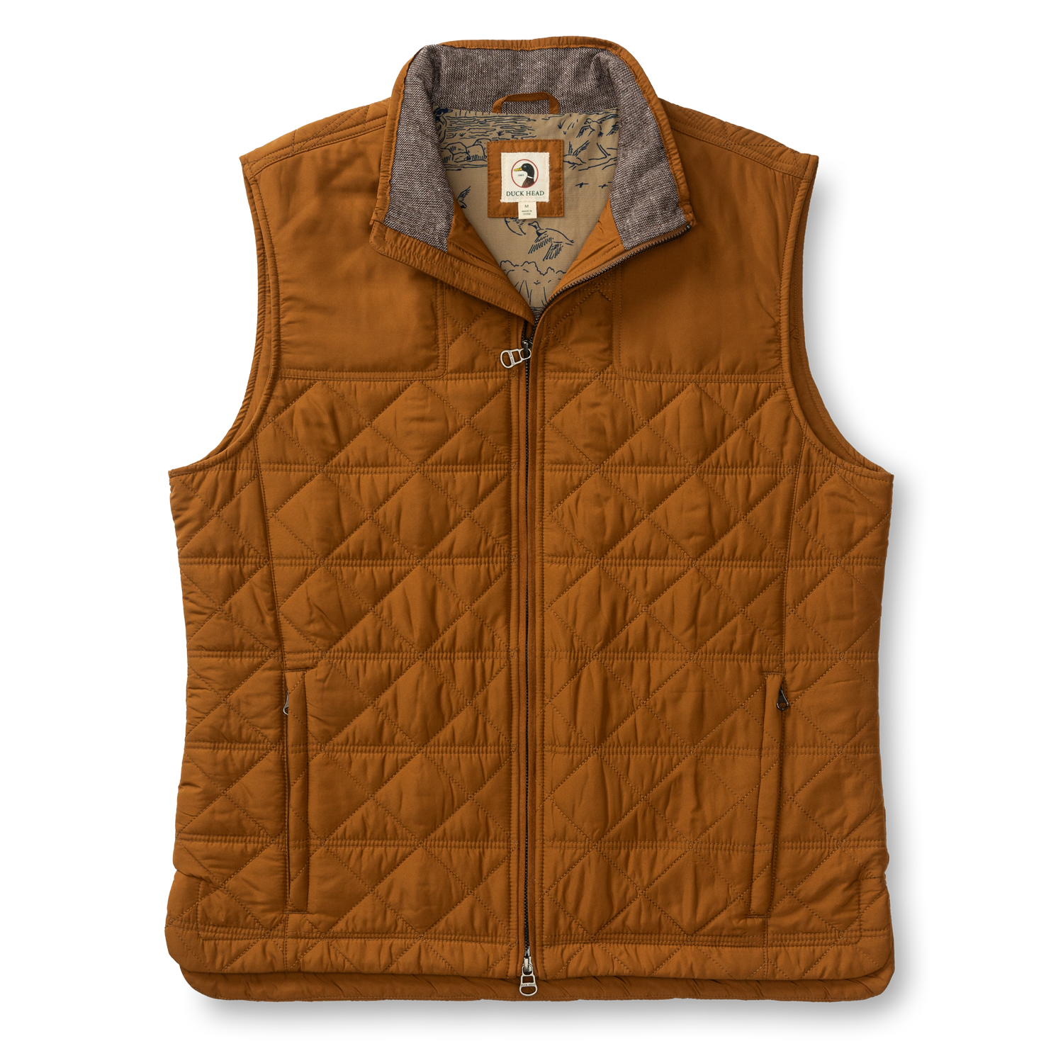 The Duck Head Fremont Sport Performance Quilted Vest features PrimaLoft Black Insulation, a front zipper, two side pockets, and a patterned inner lining—this lightweight brown vest is displayed on a white background.