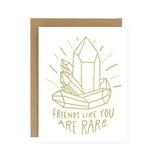 The Friends Like You Crystal Card by Worthwhile Paper features a gold crystal line drawing and the phrase "Friends like you are rare." Ideal as a thank you or birthday card. Brown envelope is partially visible behind the card.