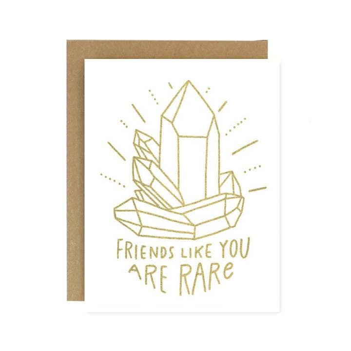 The Friends Like You Crystal Card by Worthwhile Paper features a gold crystal line drawing and the phrase "Friends like you are rare." Ideal as a thank you or birthday card. Brown envelope is partially visible behind the card.