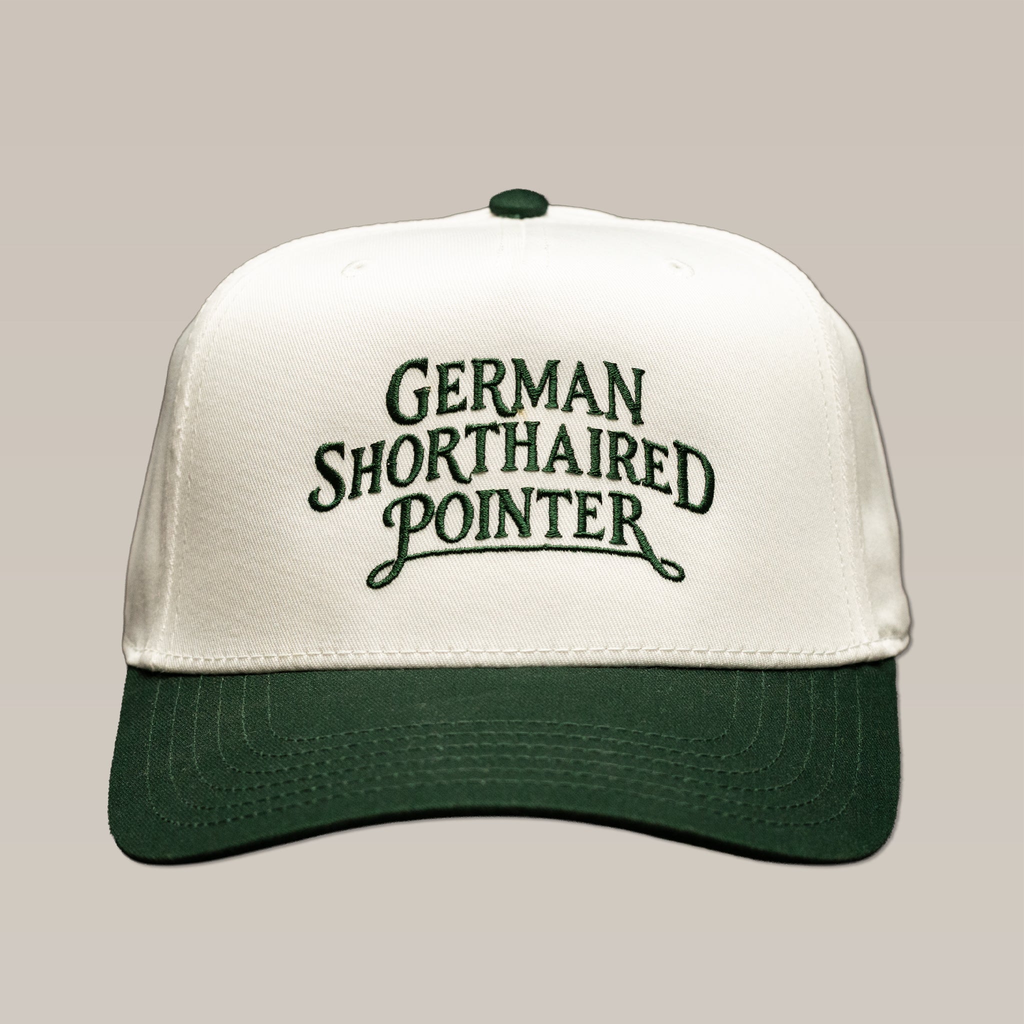 White and green Bird Dog Series Hat | German Shorthaired Pointer, embroidered with “German Shorthaired Pointer” in dark green lettering.
