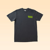 A plain black Bluebonnet Country Shirt by Ballad Originals with “Brenham Texas” printed in bright green text on the upper left chest, featuring quality construction and a comfortable everyday fit, displayed on a light beige background.
