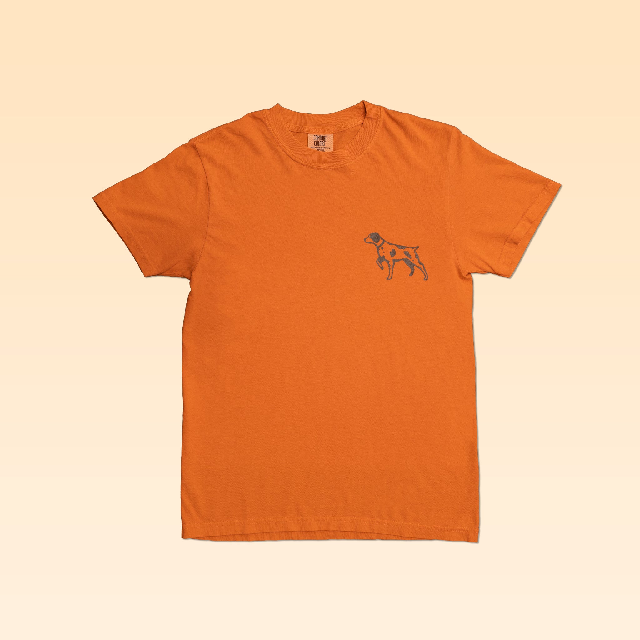 Ballad Originals Upland Shirt in orange with a small pointer dog graphic on the left chest, designed for a comfortable everyday fit.