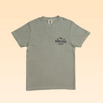 Sage green Bird Dog Series Shirt | Labrador Retriever short-sleeve t-shirt with a small graphic on the left chest featuring a silhouette of a dog above the text “BIRD DOG SERIES.”