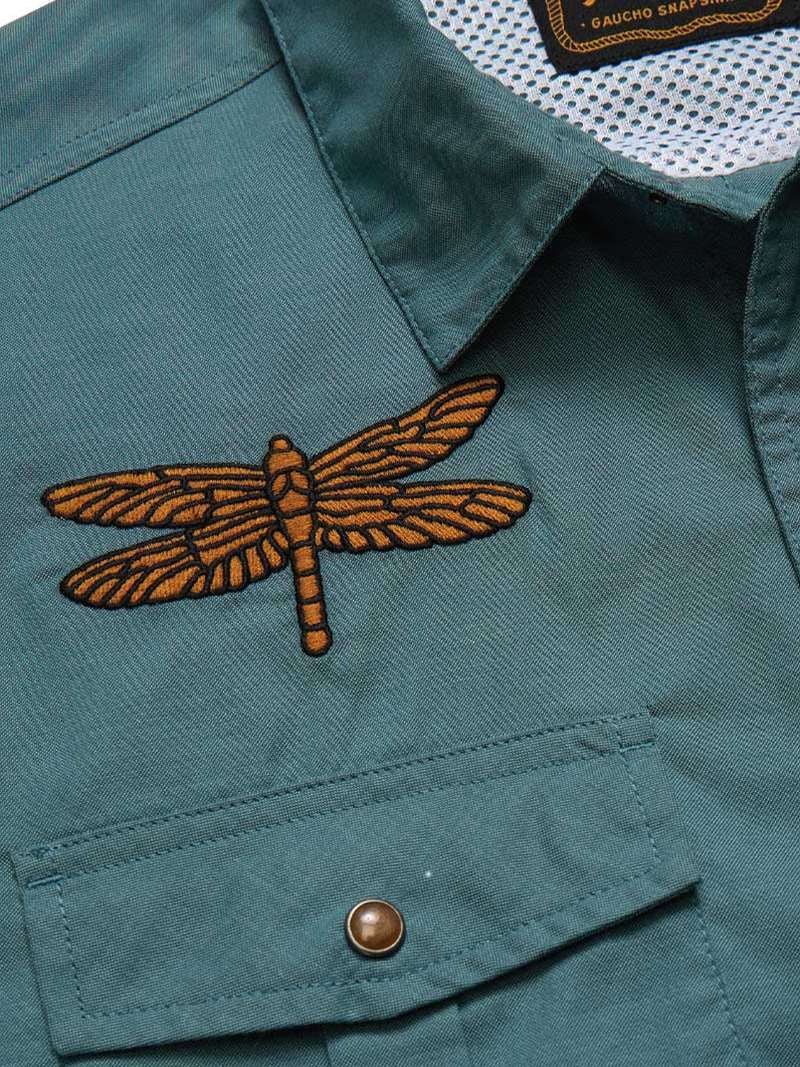 Close-up of the teal Howler Brothers Gaucho Snapshirt | Enter the Dragons, featuring a dragonfly patch embroidered above the chest pocket.