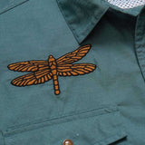 Close-up of the teal Howler Brothers Gaucho Snapshirt | Enter the Dragons, featuring a dragonfly patch embroidered above the chest pocket.