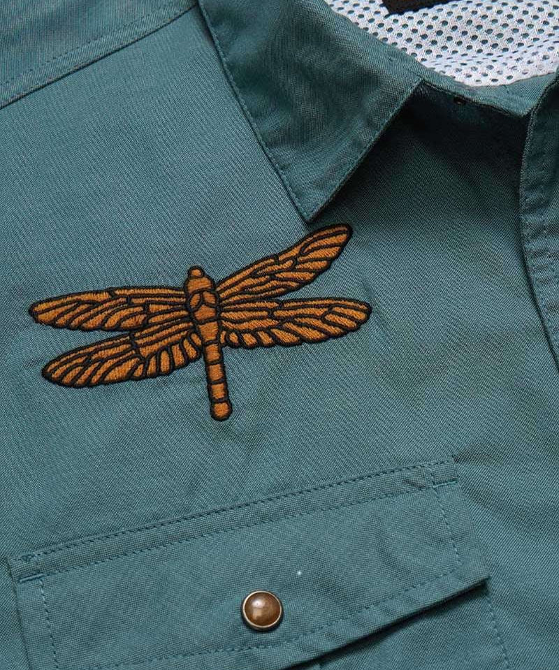 Close-up of the teal Howler Brothers Gaucho Snapshirt | Enter the Dragons, featuring a dragonfly patch embroidered above the chest pocket.