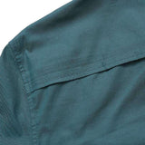 Close-up of the upper back section of the teal Gaucho Snapshirt | Enter the Dragons by Howler Brothers, highlighting the yoke seam and part of the collar.