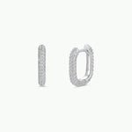 A pair of small, oval-shaped gold hoop earrings with pavé-set cubic zirconia stones from JaxKelly, shown from the front and side against a plain white background. Product: Gold Hoop - Pave | JaxKelly.