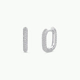A pair of small, oval-shaped gold hoop earrings with pavé-set cubic zirconia stones from JaxKelly, shown from the front and side against a plain white background. Product: Gold Hoop - Pave | JaxKelly.