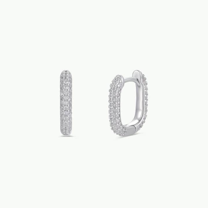 A pair of small, oval-shaped gold hoop earrings with pavé-set cubic zirconia stones from JaxKelly, shown from the front and side against a plain white background. Product: Gold Hoop - Pave | JaxKelly.