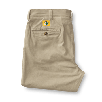 A pair of Duck Head Gold School Chino khakis features a back pocket with button closure and a distinctive big gold patch above the pocket—an iconic symbol of Duck Head’s American heritage.