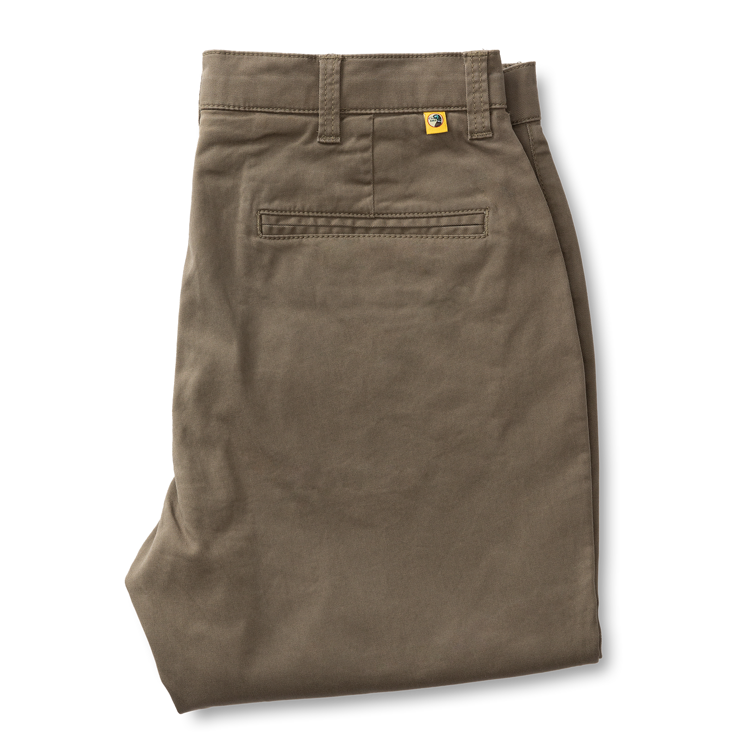A pair of Gold School Chino pants by Duck Head in olive green cotton twill, neatly folded, with belt loops, back pocket stitching, and a small yellow Duck Head tag above the pocket.