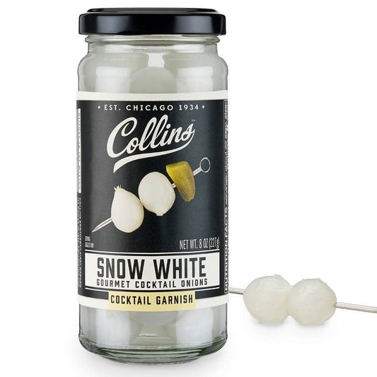 A jar of Collins Gourmet Pickled Snow White Cocktail Onions, visible inside and with two on a pick outside—ideal for garnishing classic Gibson martinis.