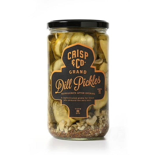 A glass jar of Crisp & Co. Grand Dill Pickles, featuring sliced Kirby cucumbers and California heirloom garlic, with the product name and brand—Grand Dill Pickles | Crisp & Co.—displayed on the front label.