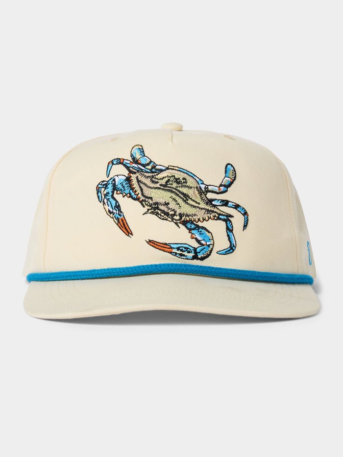 The Duck Camp Grandpa Hat Blue Crab features a beige snapback design with an embroidered blue crab, blue trim above the brim, and an adjustable polyester shell for comfort.