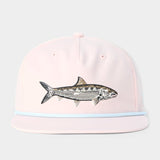 The Duck Camp Grandpa Hat Bonefish is a light pink adjustable cap with an embroidered fish design on the front and a light blue trim above the brim.
