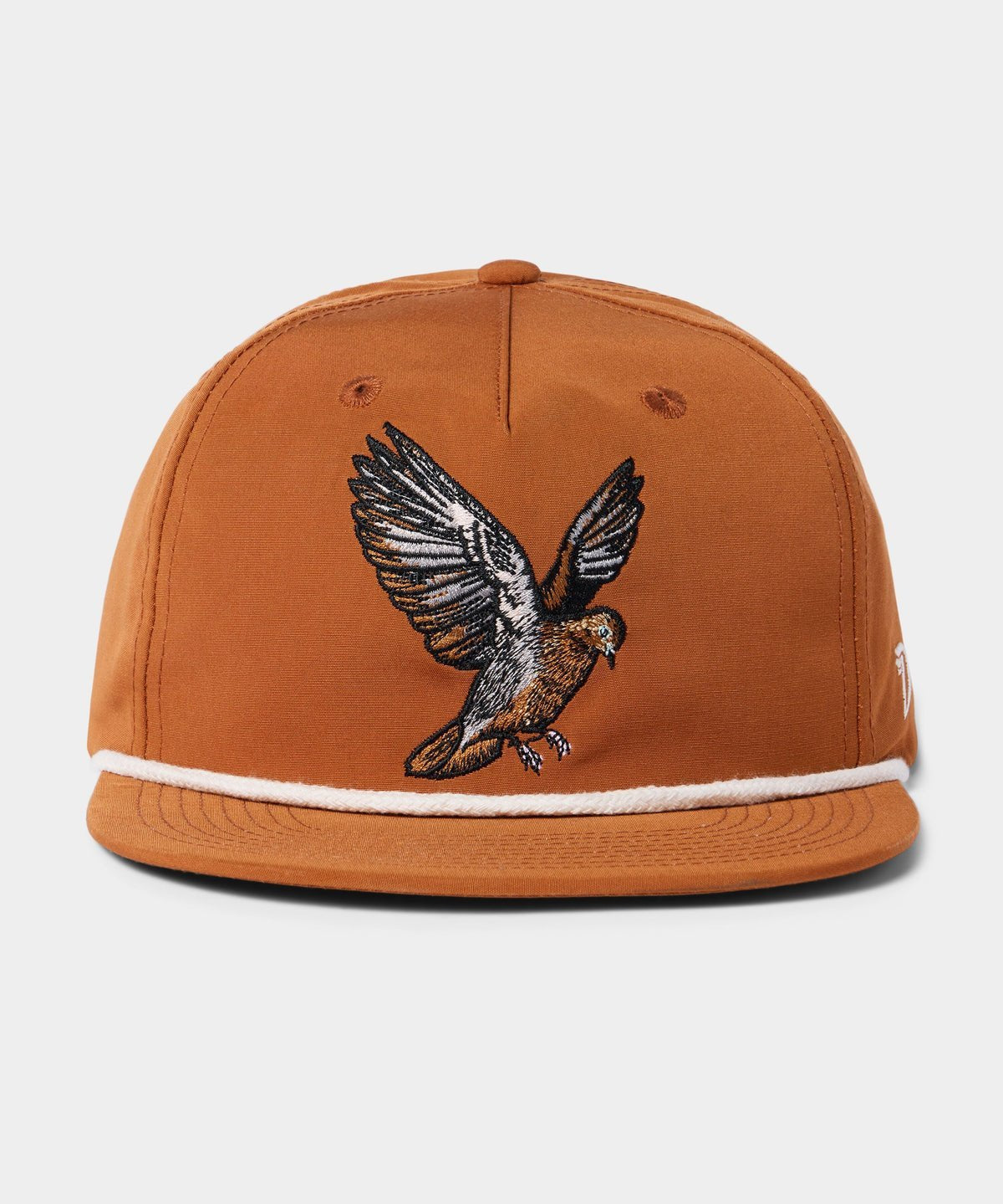The Grandpa Hat | Dove by Duck Camp is a brown snapback cap with white trim and an embroidered bird with outstretched wings, inspired by dove poppers. Features an adjustable fit.