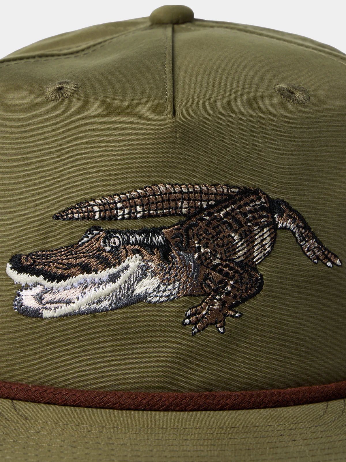Close-up of the Grandpa Hat by Duck Camp in olive green, featuring an embroidered gator on the front panel.