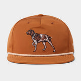 The Duck Camp Grandpa Hat | Pointer is a rust-colored 5-panel cap with an embroidered brown and white dog on the front and an adjustable snapback for a comfortable fit.