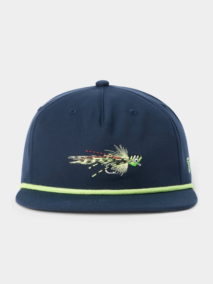 The Grandpa Hat Popper by Duck Camp is a navy blue 5-panel snapback featuring a green fishing fly embroidered on the front and a light green trim along the adjustable visor.