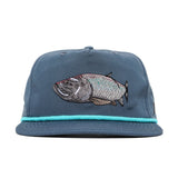The Duck Camp Grandpa Hat | Tarpon features a turquoise rope above the brim and an embroidered tarpon design on the front—an ideal, timeless cap for fishing enthusiasts.