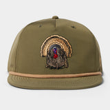 The Grandpa Hat | Turkey by Duck Camp features an embroidered turkey design, olive green color, tan cord trim above the brim, two top ventilation holes, and an adjustable snapback for a custom fit.