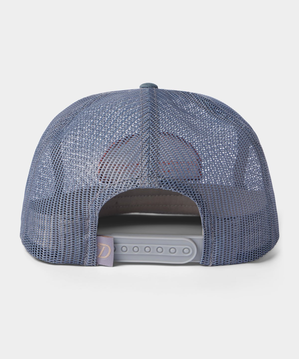 The Gulf Trucker | Cast & Blast by Duck Camp is a blue mesh hat shown from the back, featuring an adjustable snapback closure and a small fabric tag on the left side for added detail.
