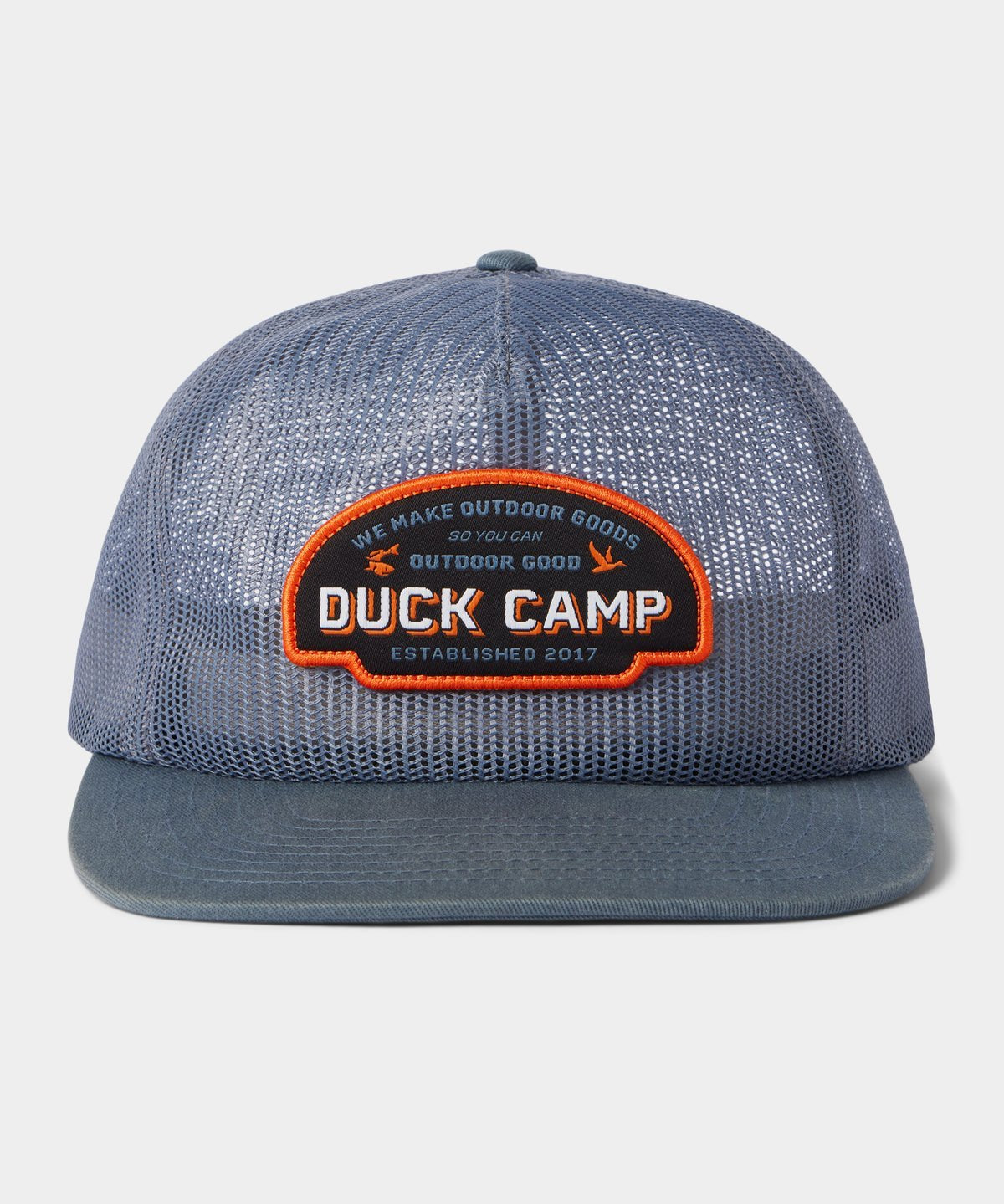 The Gulf Trucker | Cast & Blast by Duck Camp is a blue mesh hat featuring an adjustable snapback and a front patch that reads "Duck Camp" and "We Make Outdoor Goods So You Can Outdoor Good, Established 2017.
