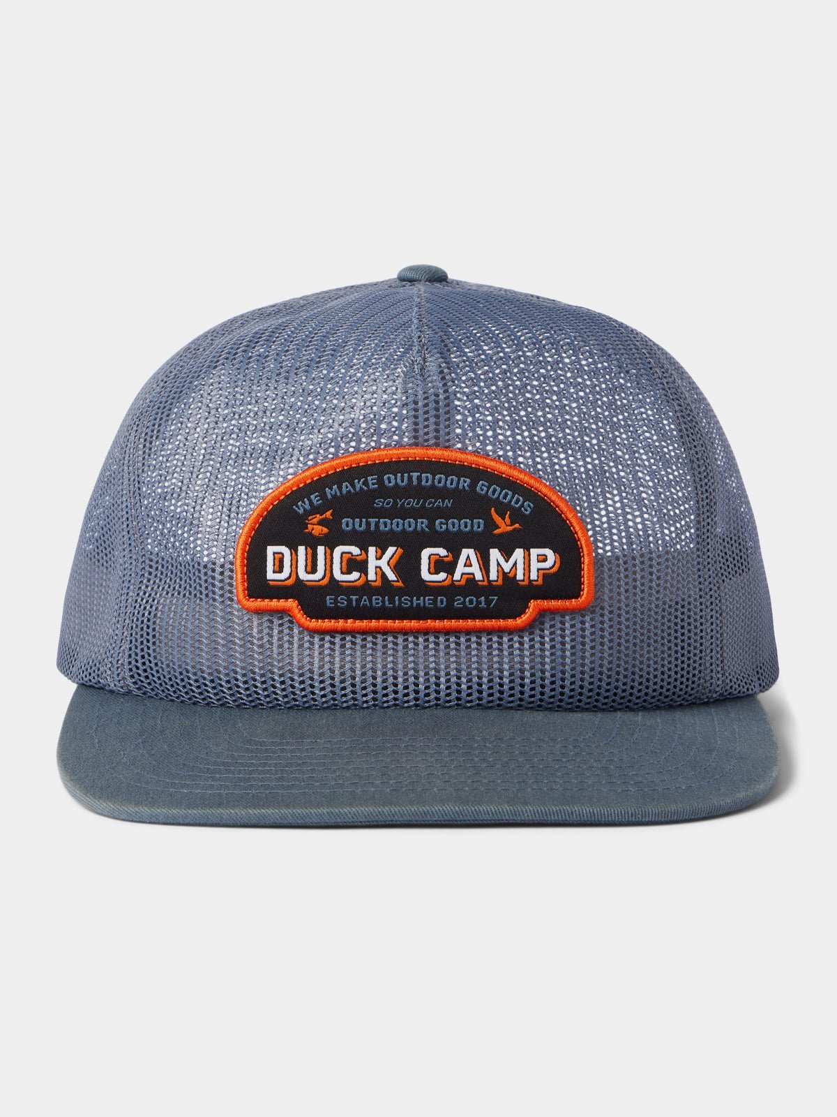 The Gulf Trucker | Cast & Blast by Duck Camp is a blue mesh hat featuring an adjustable snapback and a front patch that reads "Duck Camp" and "We Make Outdoor Goods So You Can Outdoor Good, Established 2017.