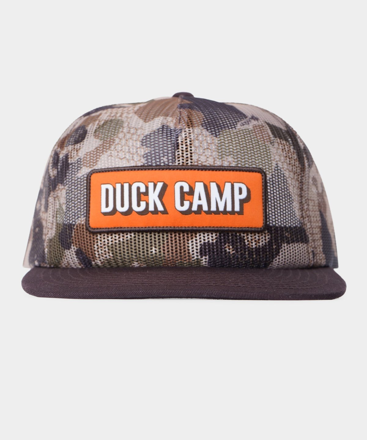 The Gulf Trucker | Wetland by Duck Camp is a camo flat-brim hat with an orange "DUCK CAMP" patch in white. It features breathable mesh panels for comfort and airflow, making it ideal for outdoor adventures.