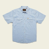 The H Bar B Snapshirt by Howler Brothers in Faded Blue Oxford features short sleeves, pearl snaps, two chest pockets, and a collar, shown against a plain background.