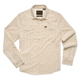 The Howler Brothers H Bar B Tech Long Sleeve shirt in beige features a subtle striped pattern, two chest pockets, and quick-drying stretch fabric for comfort.