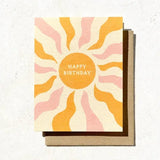 The Happy Birthday Boho Sun Card by Daydream Prints features a sun with wavy orange and pink rays and "Happy Birthday" in the center—an eco-conscious card perfect for fans of unique stationery and laid-back, surf-inspired gifts.