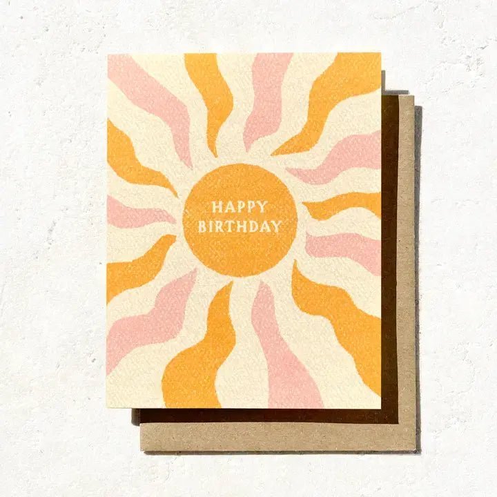 The Happy Birthday Boho Sun Card by Daydream Prints features a sun with wavy orange and pink rays and "Happy Birthday" in the center—an eco-conscious card perfect for fans of unique stationery and laid-back, surf-inspired gifts.