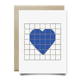 The Heart | Houston Blue Tile Greeting Card by Anvil Cards features a hand-drawn blue heart of rectangles on a gray grid, printed on sustainable linen paper with a brown envelope.