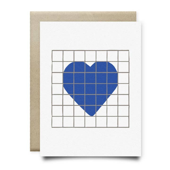 The Heart | Houston Blue Tile Greeting Card by Anvil Cards features a hand-drawn blue heart of rectangles on a gray grid, printed on sustainable linen paper with a brown envelope.