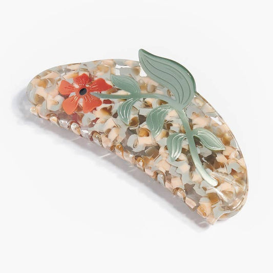 The Hesperides Large Hair Claw by Winona Irene features a marbled beige cellulose acetate base accented with a red flower and green leaf pattern.