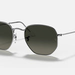 Ray-Ban 3548 Hexagonal Flat Arista sunglasses feature silver metal frames, flat crystal lenses with a dark green tint, and a subtle logo on the top left lens, displayed on a plain background.