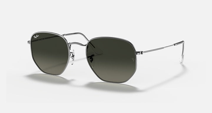 A pair of Ray-Ban 3548 Hexagonal Flat Arista sunglasses with silver frames, dark flat crystal lenses, and thin arms is displayed on a plain background.