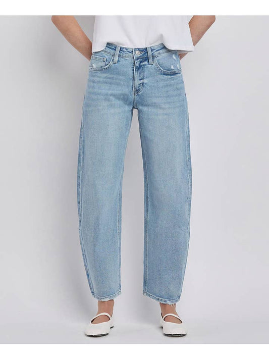 Person wearing Vervet High Rise Light Wash Barrel Leg Jeans, a white t-shirt, and white flats, standing against a plain light background.