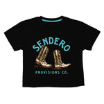 The High Stepper Boxy Tee by Sendero Provisions Co. is a black, soft organic cotton shirt featuring two illustrated cowboy boots and "Sendero Provisions Co." in light blue text above and below the design. Easy fit for daily comfort.