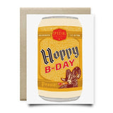 Hoppy B-Day Shiner Birthday Card by Anvil Cards features a hand-drawn beer can and ram, printed on sustainable linen paper with a brown envelope.