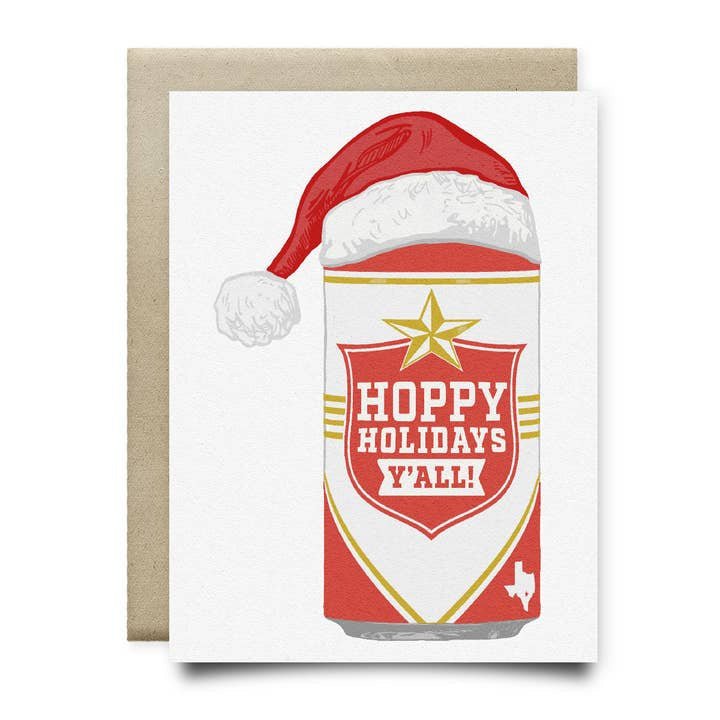 The Hoppy Holidays Lone Star Beer Card by Anvil Cards features a hand-drawn beer can in a Santa hat with "Hoppy Holidays Y'all!" and a Texas outline, printed on sustainable linen paper. Includes envelope.