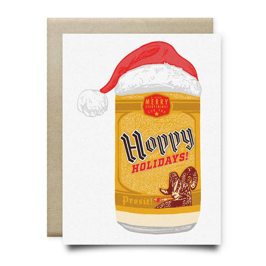 The Hoppy Holidays Shiner Card by Anvil Cards features a hand-drawn beer can in a Santa hat with "Hoppy Holidays!" and "Merry Everything" on sustainable linen paper. Blank inside for your message.
