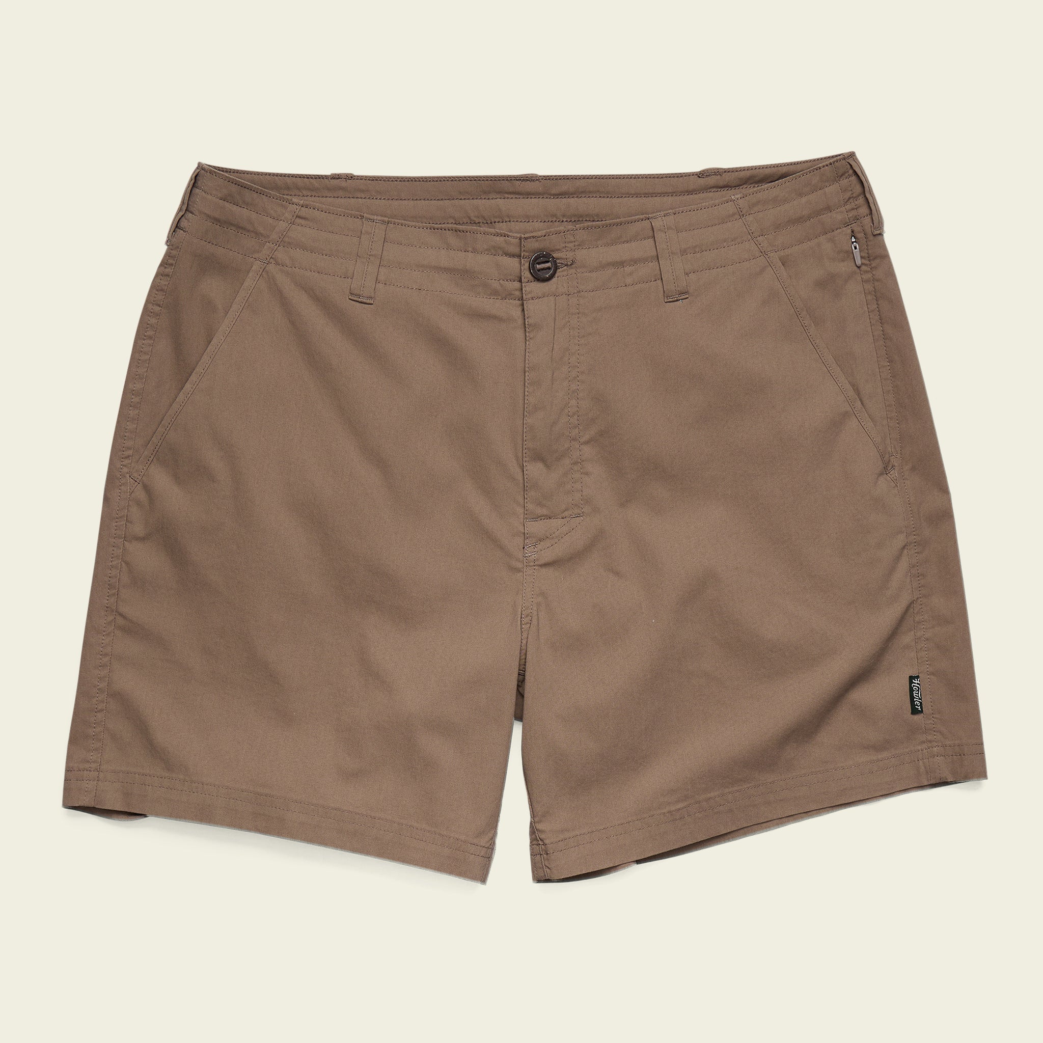The Howler Brothers Horizon Walk Shorts are brown men's casual shorts with a front button and zipper, slanted side pockets, and a small black label near the right hem, shown on a plain background.