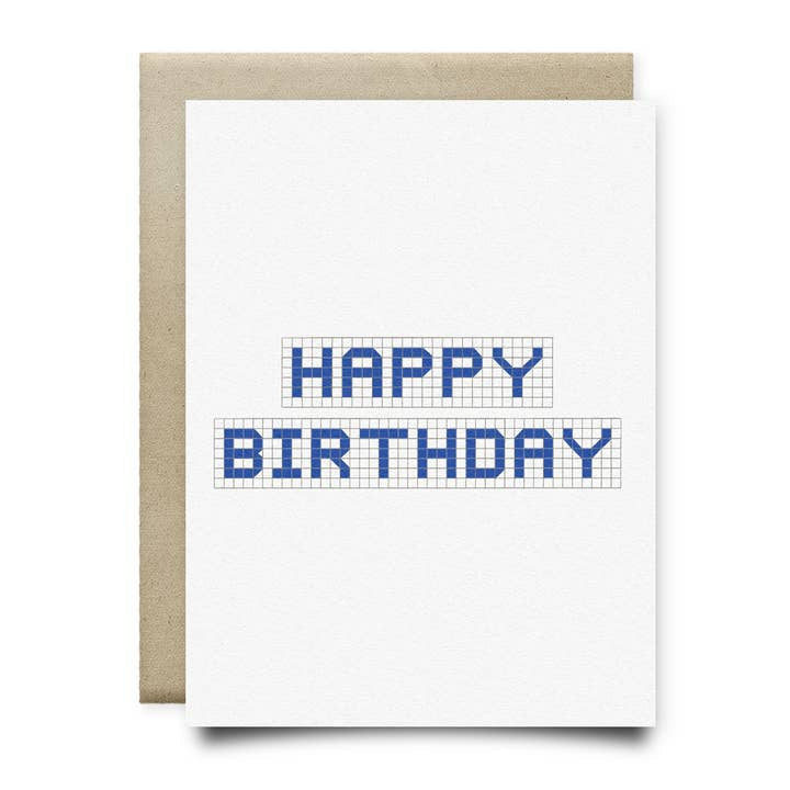 The Houston Blue Tile Birthday Card by Anvil Cards is a blank greeting card on sustainable linen paper, featuring "HAPPY BIRTHDAY" in blue block letters over a grid design and paired with a brown envelope.