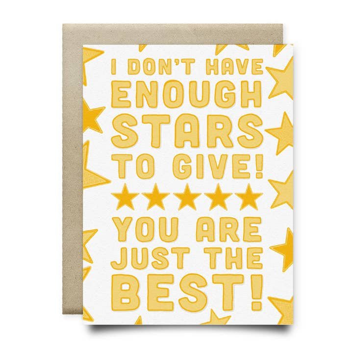 The "I Don't Have Enough Stars To Give | Anvil Cards" greeting card by Anvil Cards features a hand-drawn design with yellow stars and bold text, shown on an A2 card atop a brown envelope.