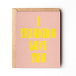 The "I Freaking Love You" card by Daydream Prints features bold yellow text on a pink retro design and comes with a brown envelope.